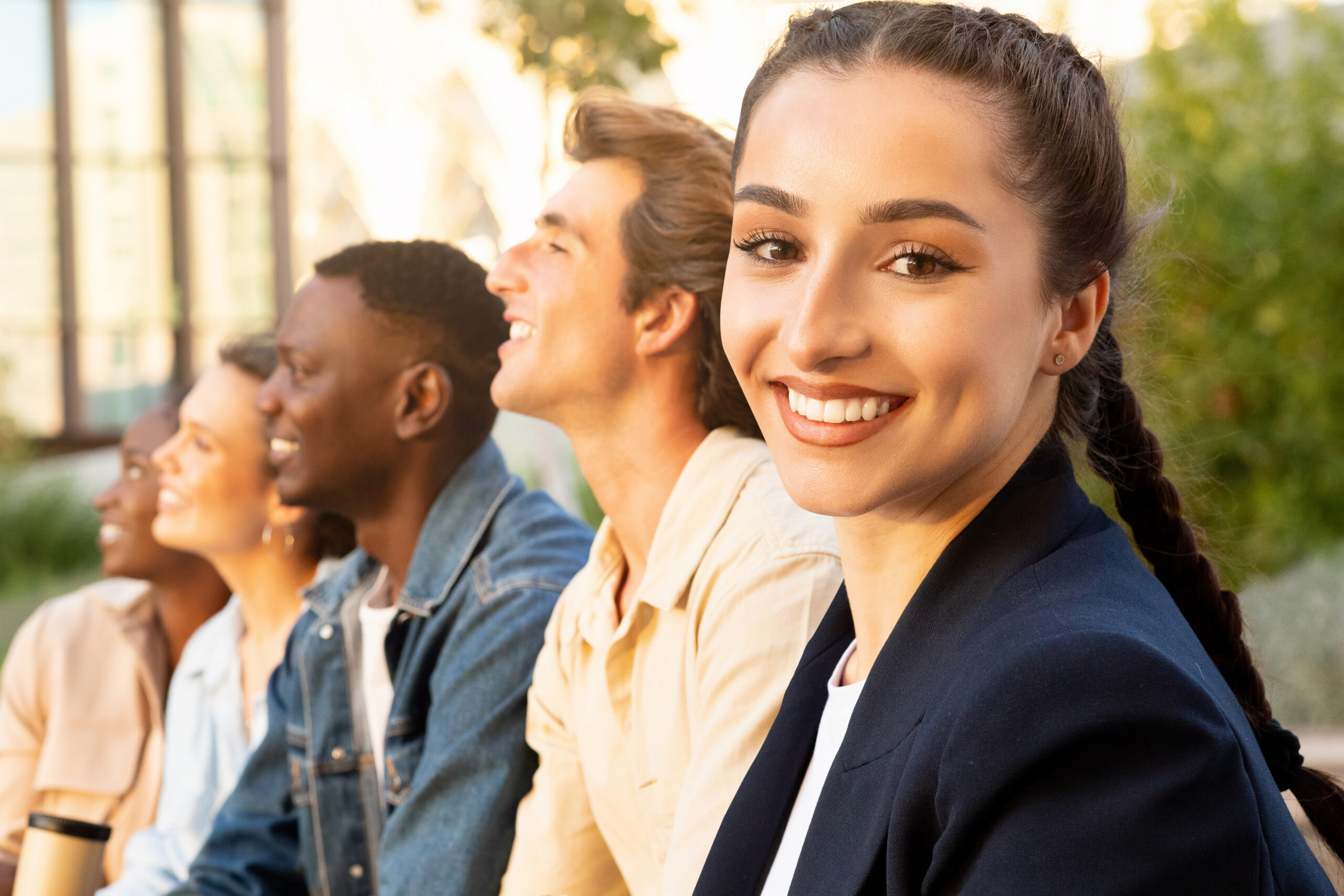 A summer sales intern smiling with colleagues